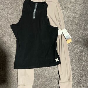 Vuori Black Crew Tank and tan pocket leggings